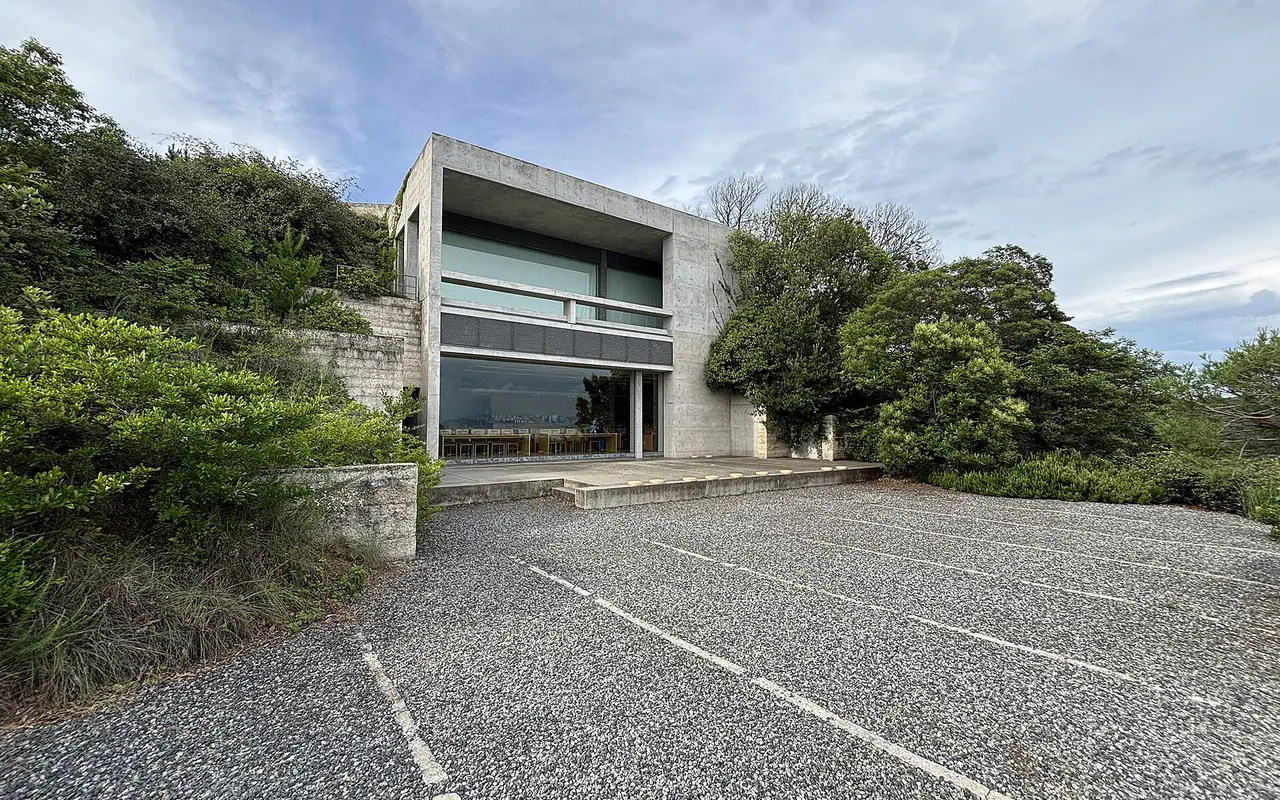 Bare concrete walls and a glass-fronted block of the Chichu Art Museum set into a green hillside