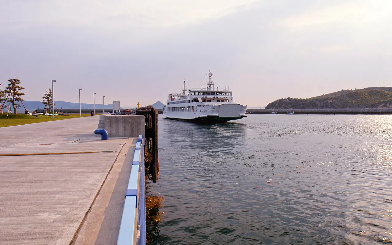 A white passenger ferry arriving at Miyanoura port on Naoshima