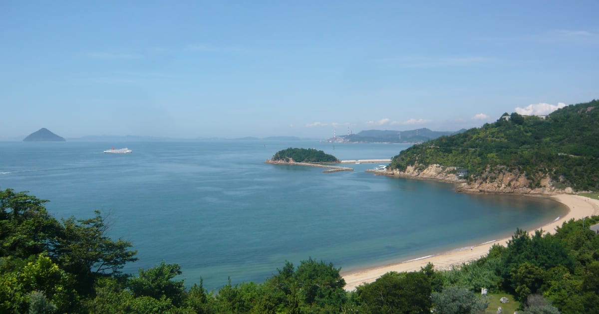 The Seto Inland Sea from the south of Naoshima, a curved bay and small islands under a clear sky